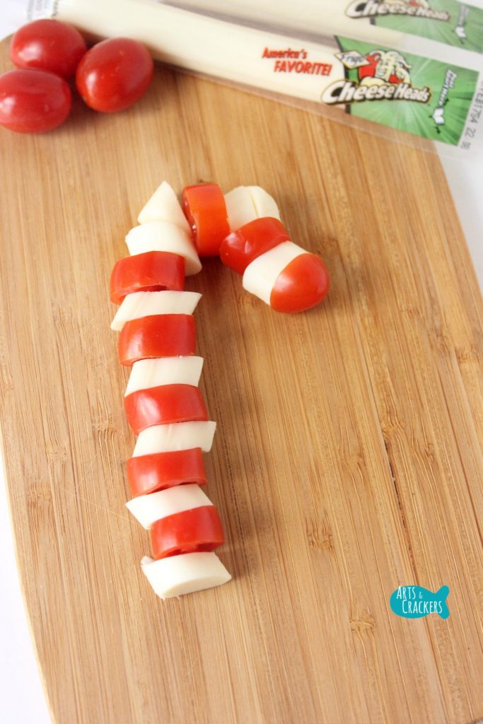 This String Cheese Candy Cane is sure to bring some Christmas magic to snack and lunchtime. | String Cheese Snack | String Cheese Wrapper | Christmas Snack Ideas | Christmas | Christmas Treat | Healthy Snacks | Snacks for Kids | Fun Lunch | Cute Snacks | Edible Crafts | String Cheese Wrapper Crafts | Reindeer Crafts | Candy Cane Snacks | Christmas Tree Snacks | Christmas Present Craft | Snowflake Snacks | Winter Treats | Lunch Box Ideas | Christmas Food for Kids | Candy Cane