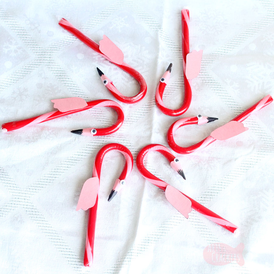 This cute DIY Flamingo Candy Cane Craft for Christmas is fun for a Hawaiian Christmas party or for our Alice in Winter Wonderland Christmas party theme | kid crafts | flamingo craft | candy cane treat | flamingo candy cane | edible flamingo treat | fun food ideas | edible craft | Christmas candy cane ornament | flamingo ornament #christmas #kidscrafts #flamingo