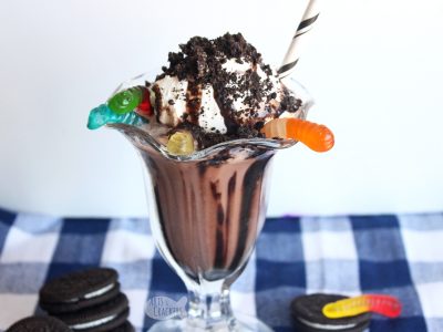 Taste the nostalgia of childhood with this decadent Dirt Cake Chocolate Shake — a Gluten Free Milkshake Recipe. You'll love the chocolate flavor, crunchy sandwich cookies, and chewy gummy worms in this frozen chocolate beverage | milkshake | gluten free recipe | dirt cups | chocolate pudding | oreos | frozen beverages | summer drinks | non-alcoholic drinks | blended drinks | chocolate #milkshake #dirtcake #foodblogger #recipe