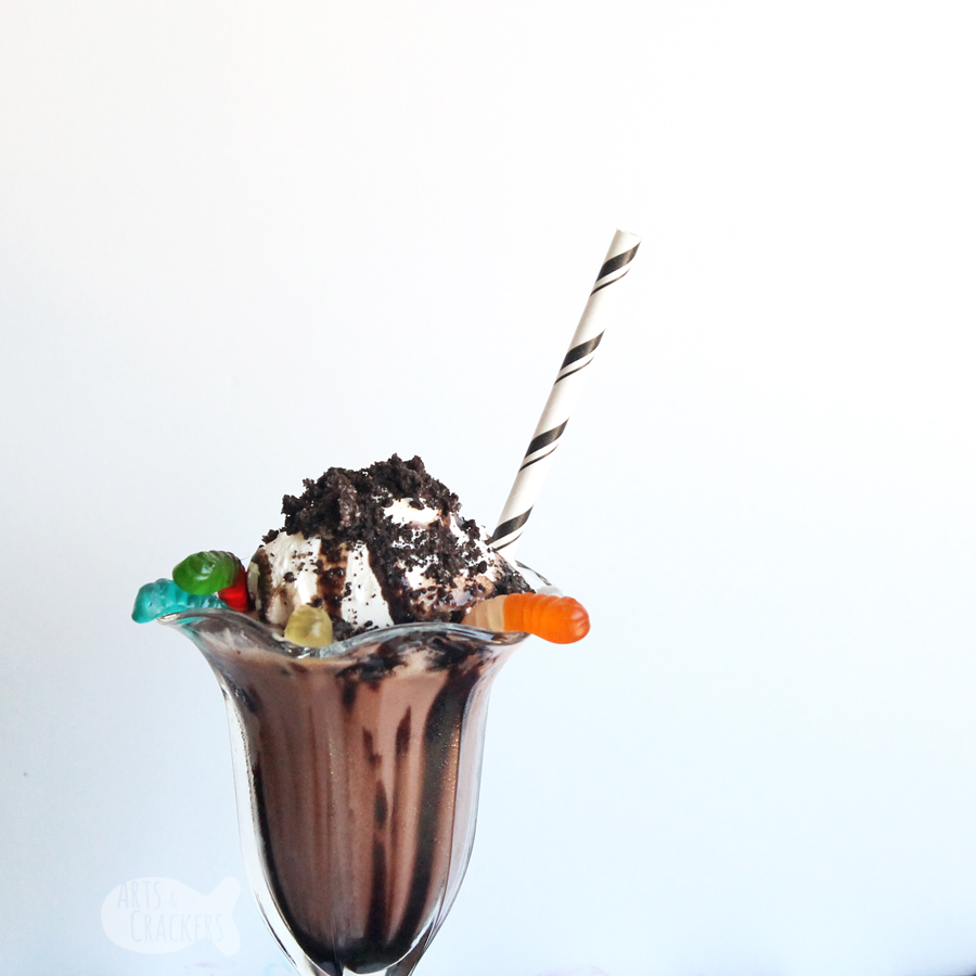 Taste the nostalgia of childhood with this decadent Dirt Cake Chocolate Shake — a Gluten Free Milkshake Recipe. You'll love the chocolate flavor, crunchy sandwich cookies, and chewy gummi worms in this frozen chocolate beverage | milkshake | gluten free recipe | dirt cups | chocolate pudding | oreos | frozen beverages | summer drinks | non-alcoholic drinks | blended drinks | chocolate #milkshake #dirtcake #foodblogger #recipe